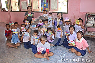 Asian primary student group shows off the gift drawing. Editorial Stock Photo